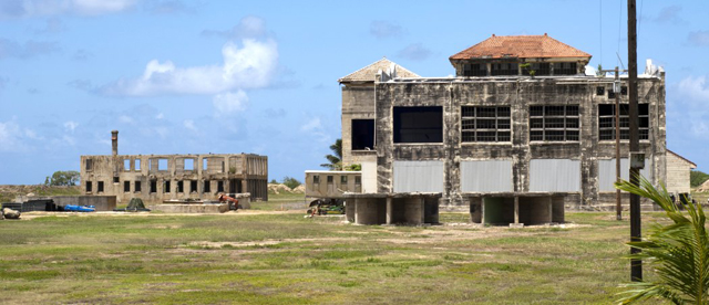 The ruins of the Marconi power generating station (foreground) and derelict hotel in the background at Kahuku. Timothy Williamson